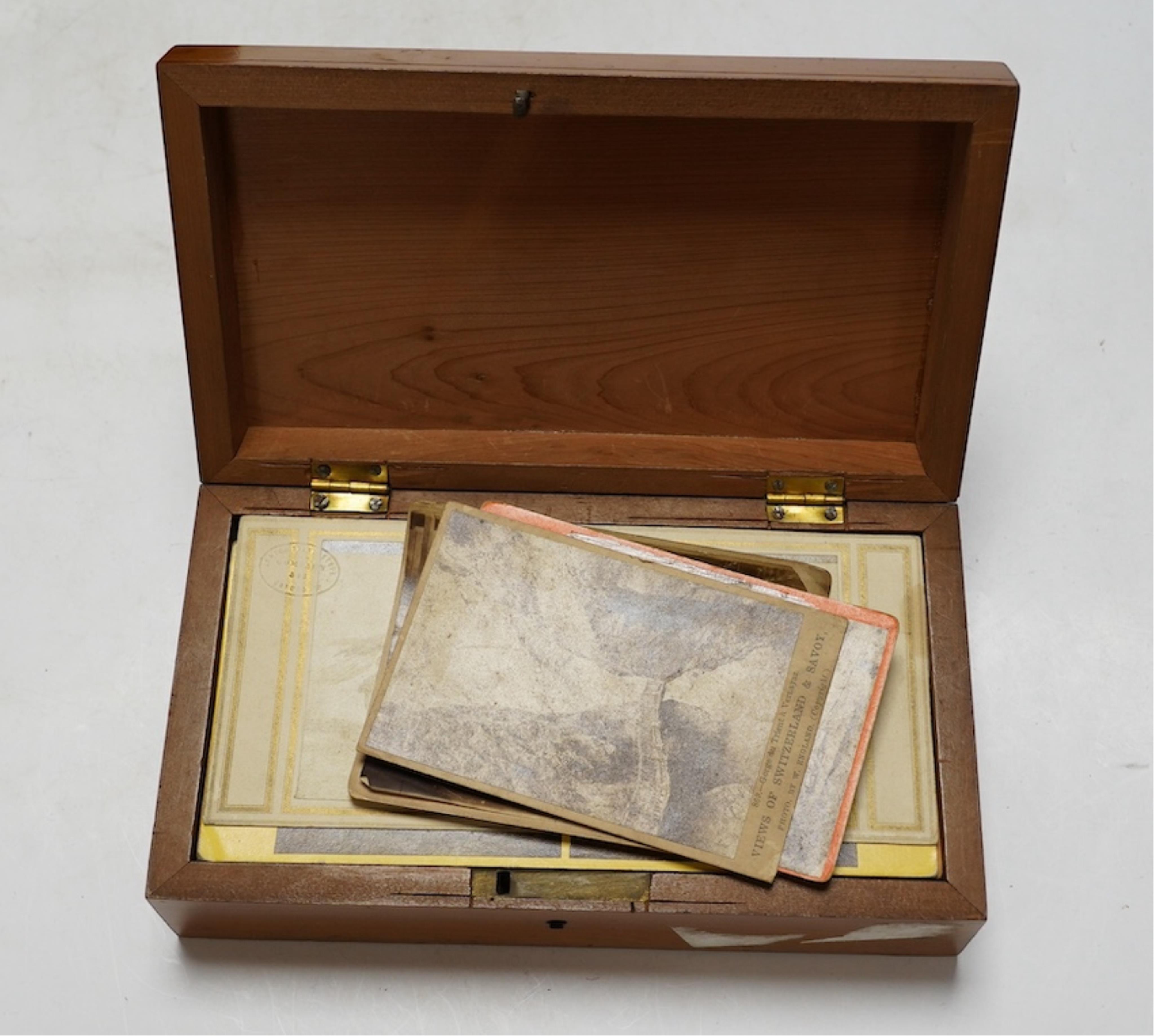 A late 19th century cased stereoscopic viewer together with topographical and other cards. Condition - fair